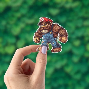 A hand holding a Bigfoot sticker that looks like Mario