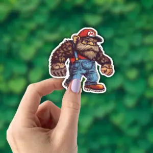 Hand holding a Bigfoot sticker that looks like Mario